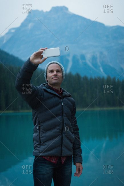 Man taking a selfie near the lake