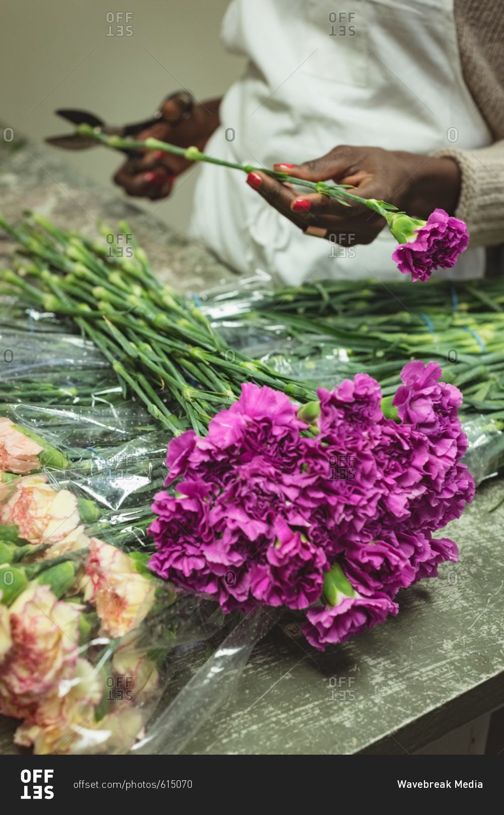 Female florist preparing bouquet of flower at his flower shop