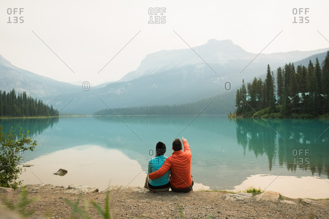 Hiker couple sitting near the lake