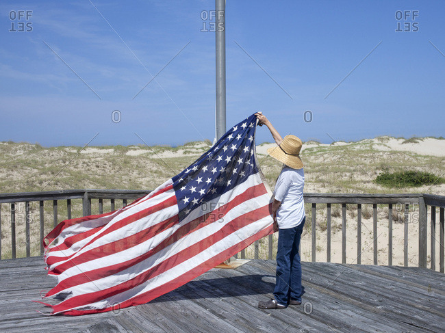 Person raising the American flag