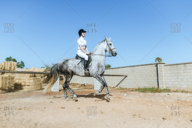 Young woman riding on horse