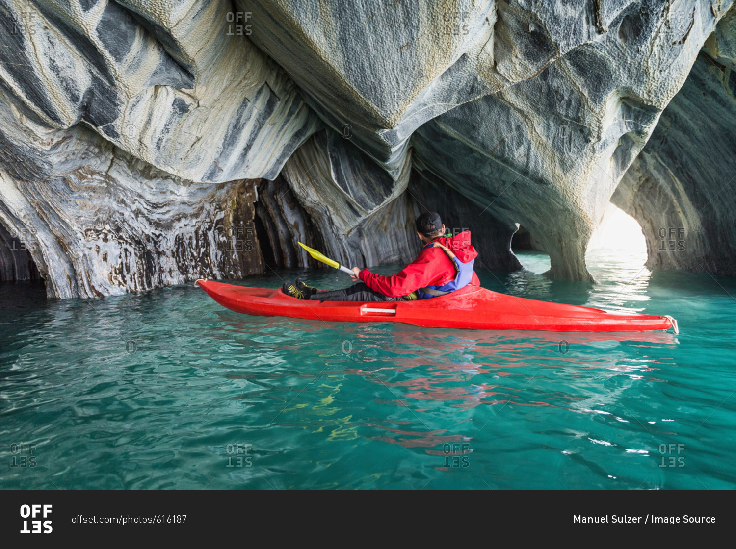 Man kayaking around marble caves, Puerto Tranquilo, Aysen Region, Chile, South America
