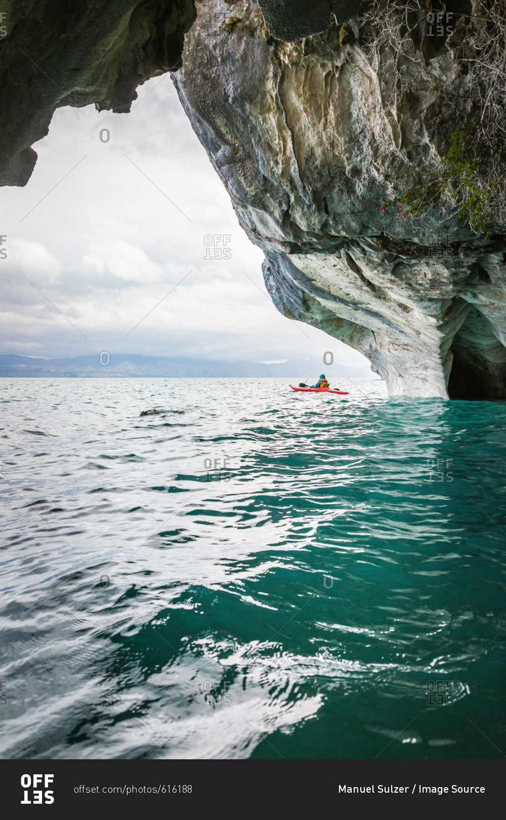 Woman kayaking around marble caves, Puerto Tranquilo, Aysen Region, Chile, South America