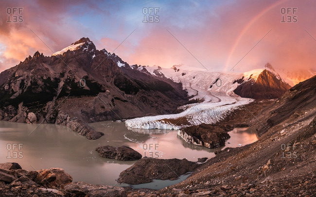 Rainbow and dramatic pink sky over Torre glacier and laguna in Los Glaciares National Park, Patagonia, Argentina