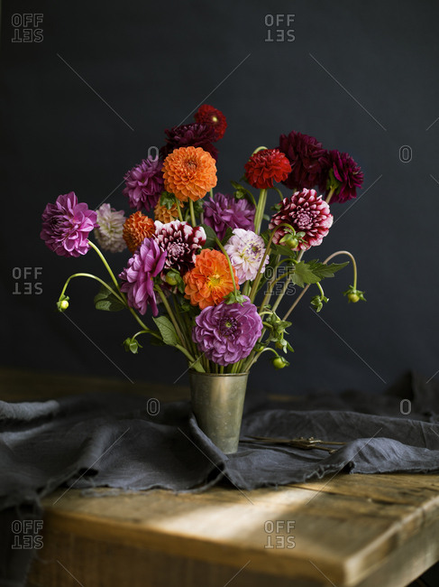 A bouquet of Dahlias in a metal vase