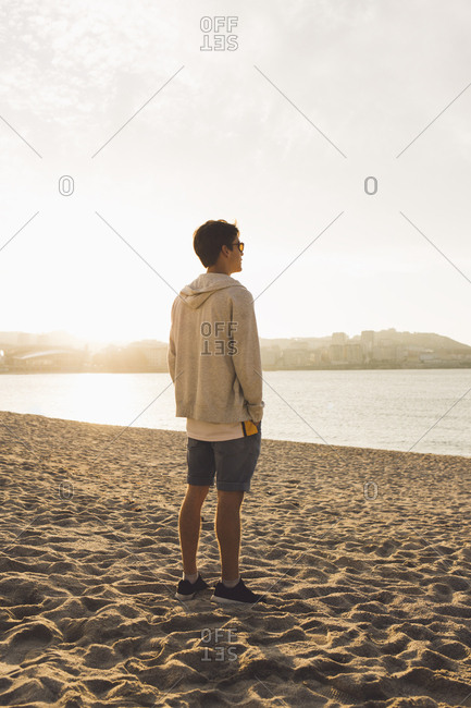 Young man on the beach - fashion Stock Photo - Alamy