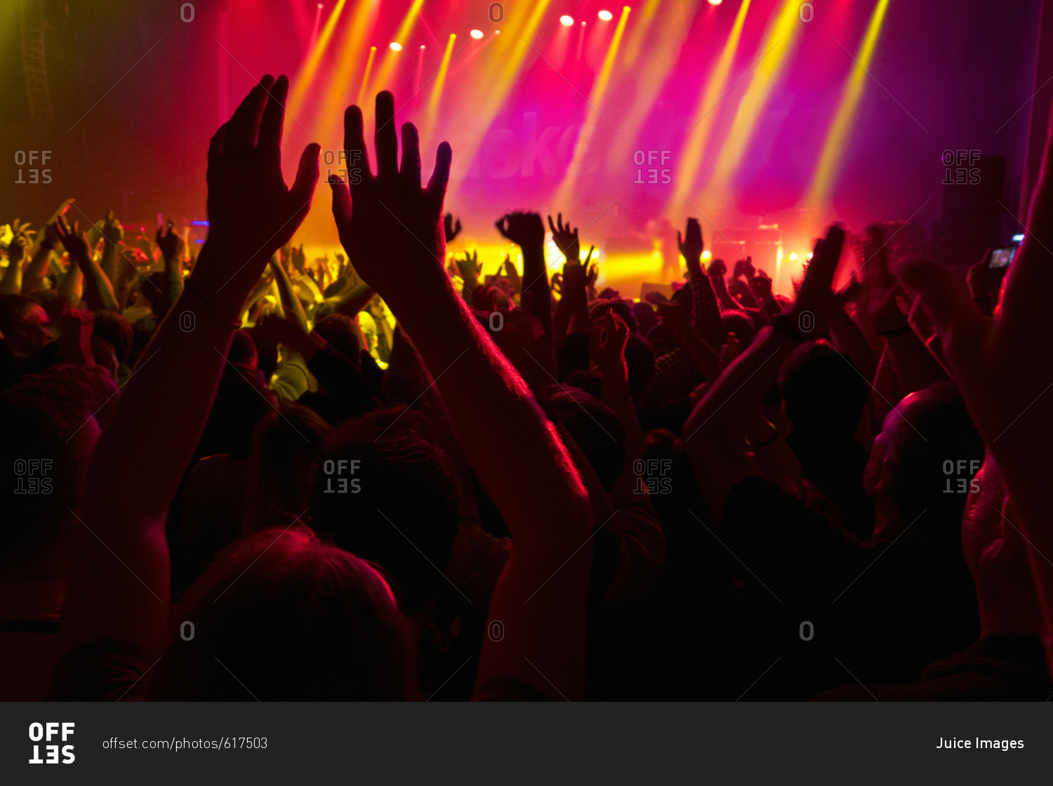 View Of Fans Enjoying Rock Concert With Light Show stock photo OFFSET