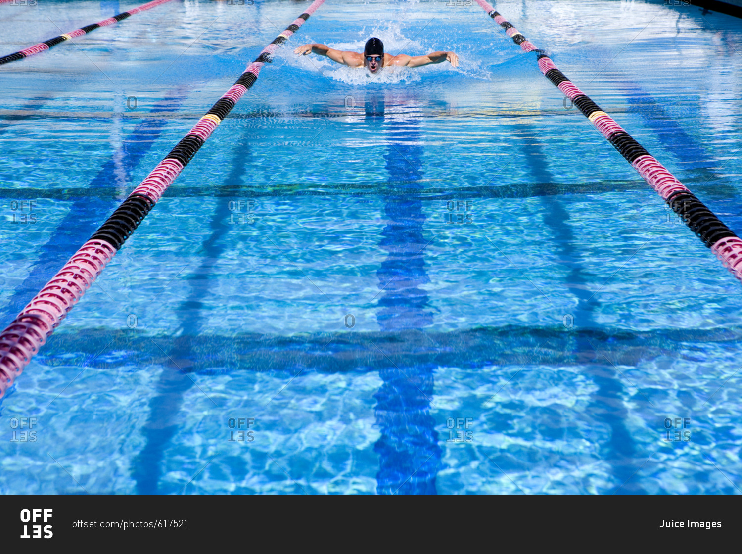 Young man swimming in lane in swimming pool
