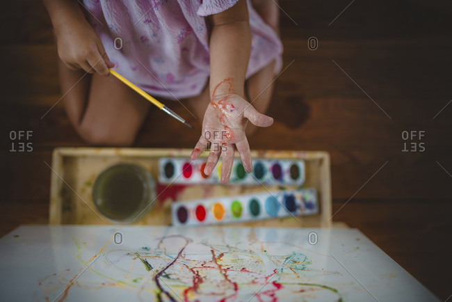 Girl with messy hands while painting
