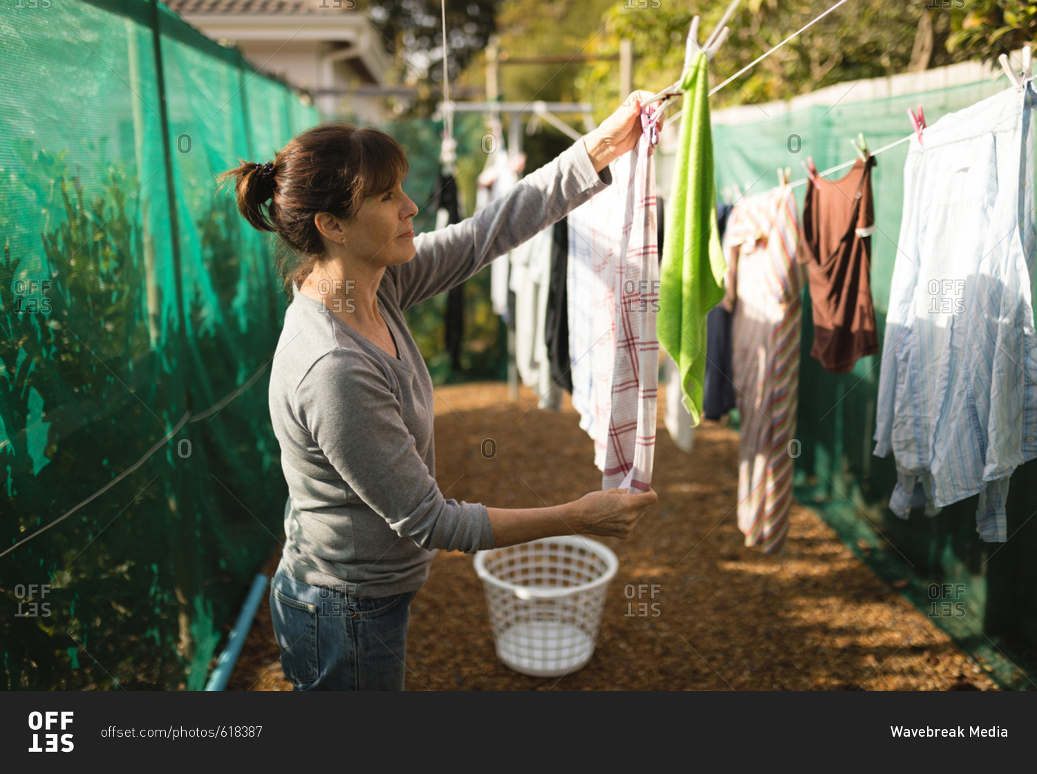 woman hand hanging bra in fresh air drying in the sunny day Stock Photo