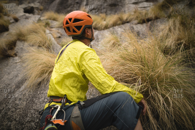 Thoughtful man preparing for mountaineering