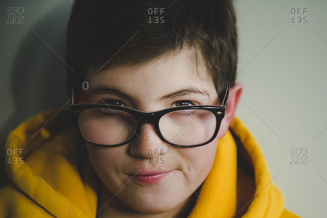 Boy with glasses in yellow sweatshirt