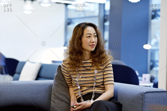 Woman in an office holding phone