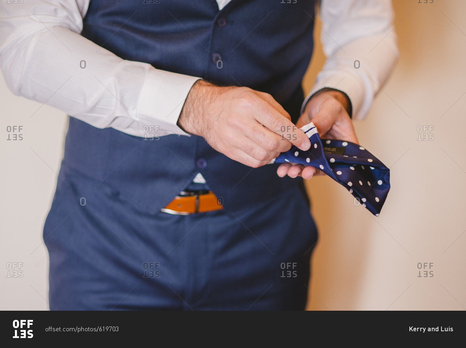Groom folding his pocket square