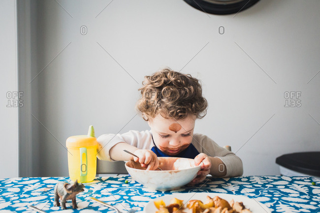 Toddler with messy face eating