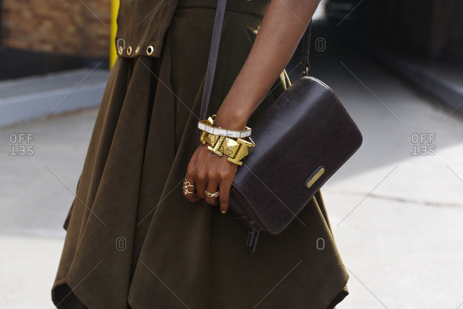 New York, NY - September 14, 2017: Fashionable woman in brown outfit with multiple accessories