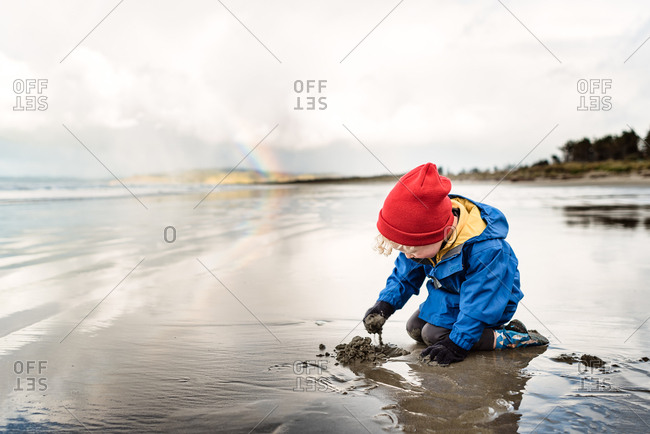 Boy plays on beach in Hawke's Bay, New Zealand