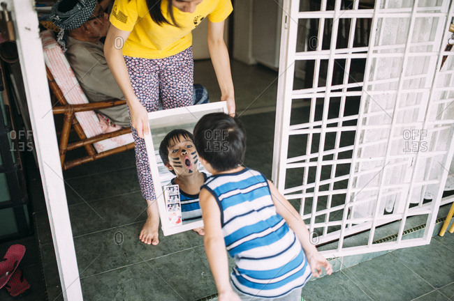 Young child in face paint looking at reflection
