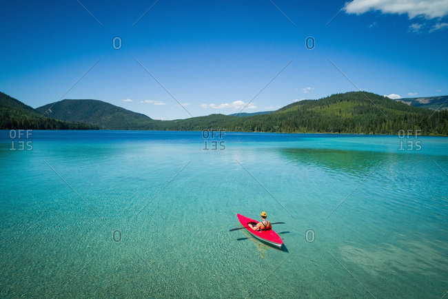 Man kayaking in lake on a sunny day