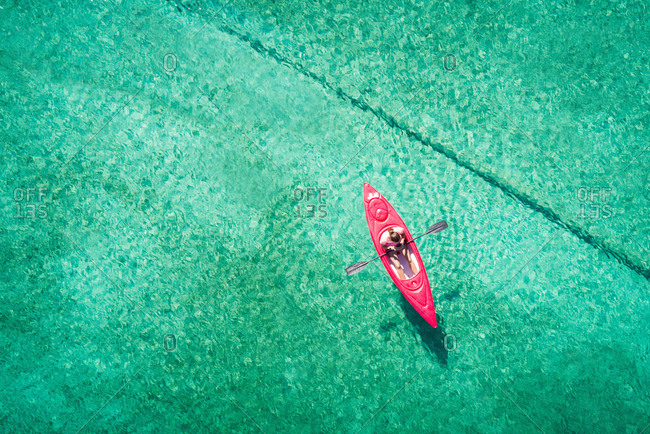 Man kayaking in lake on a sunny day