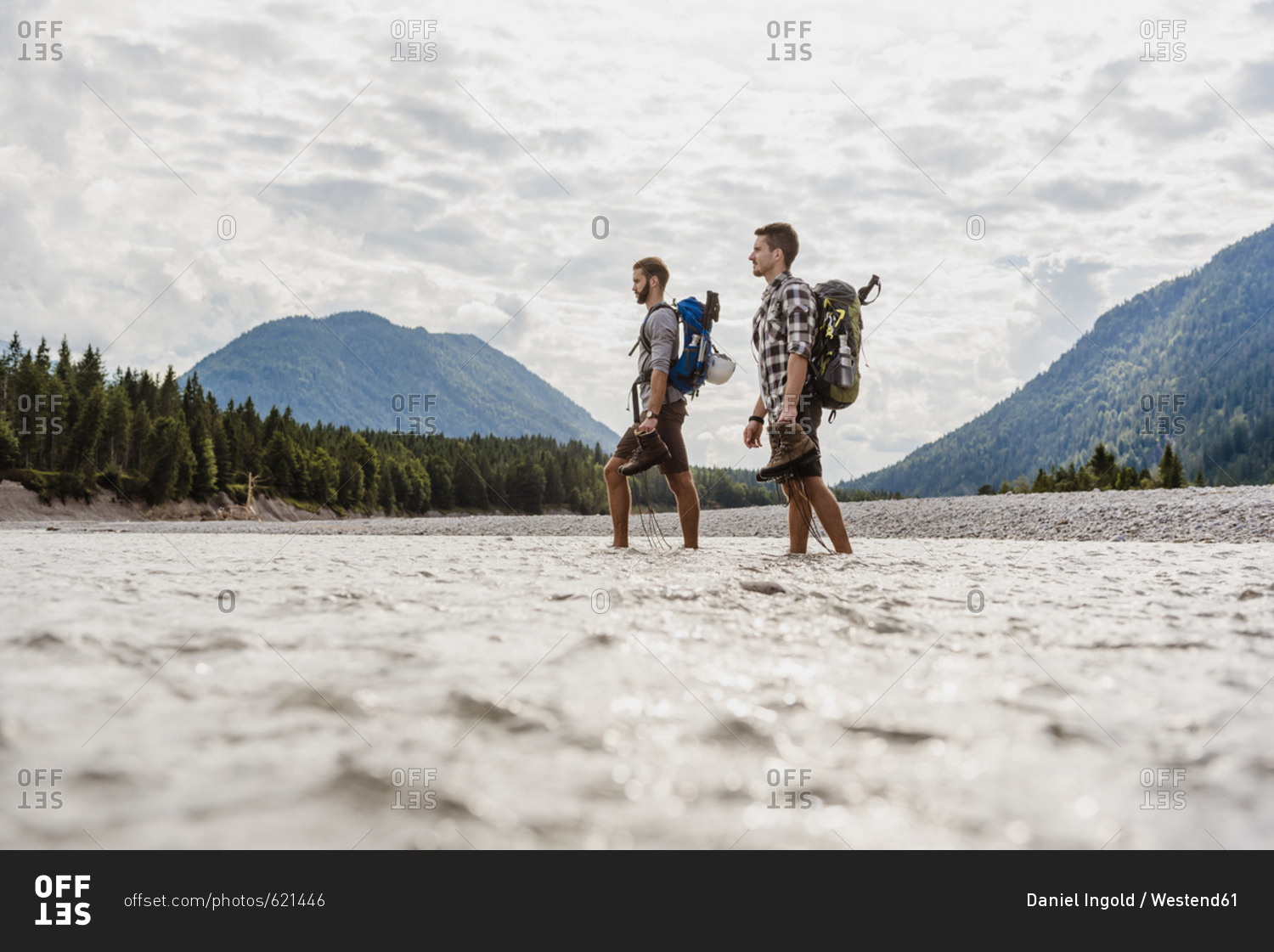 Germany- Bavaria- two hikers with backpacks crossing Isar River