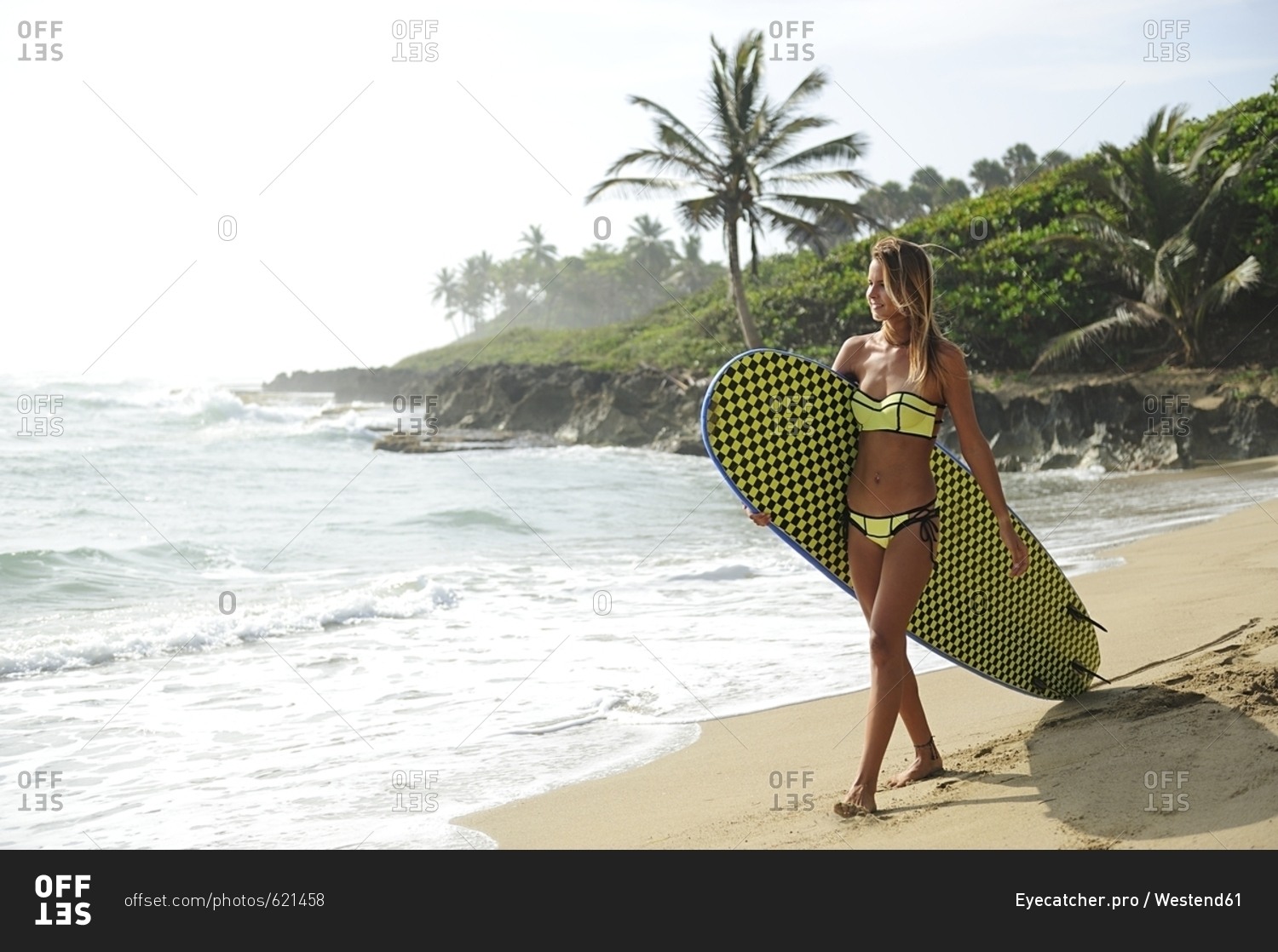 Woman on the beach with surfboard
