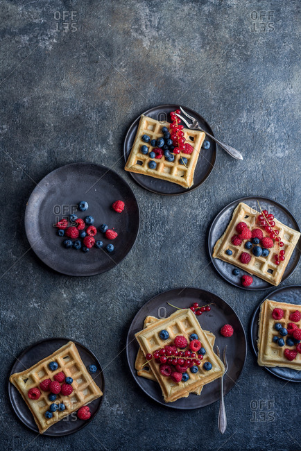 Waffles with fruit on plates