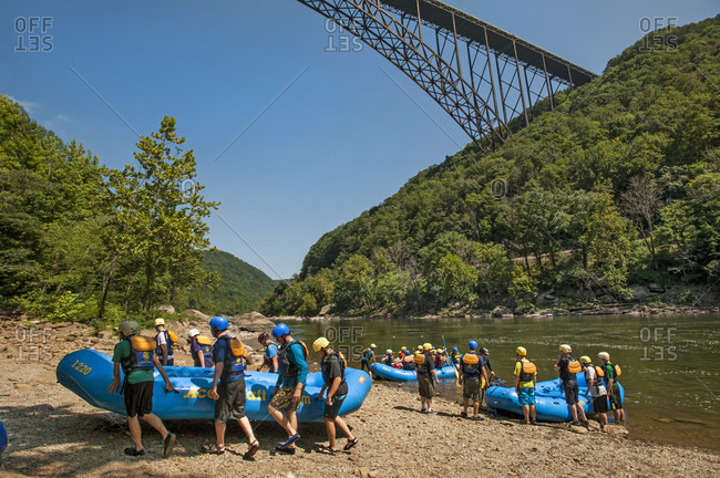 July 26, 2014: Order of the Arrow scouts carry a raft from the take out below the New River Gorge bridge, after a whitewater adventure on the New River, near Fayetteville, outside of the Summit Bechtel Reserve,  WV.