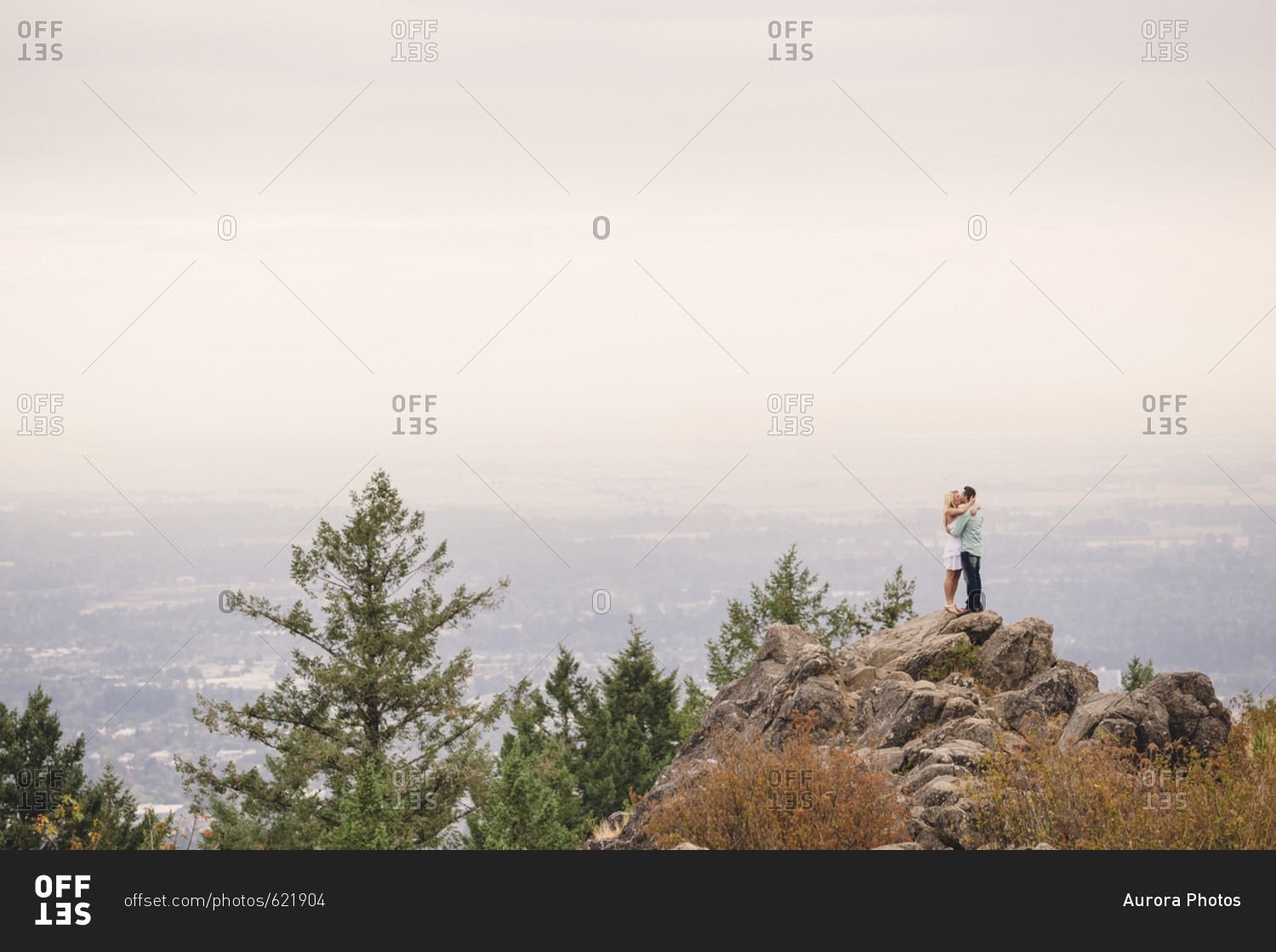 Side view of young couple hugging on top of hill during daytime, Eugene, Oregon, USA