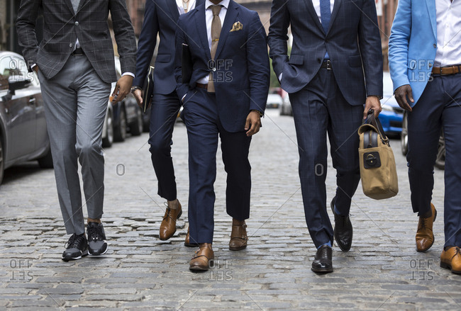 Group of men in stylish suits walking down street - Stock Image - Everypixel