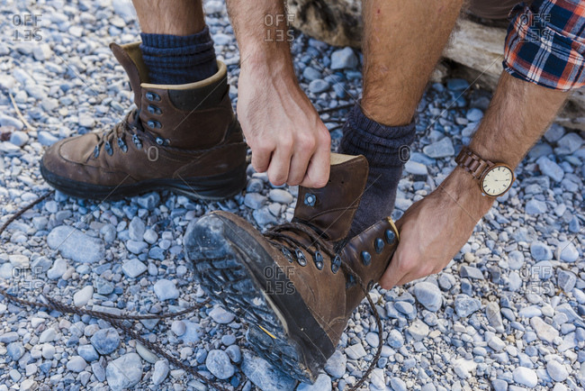 Hiker putting on his shoes- partial view