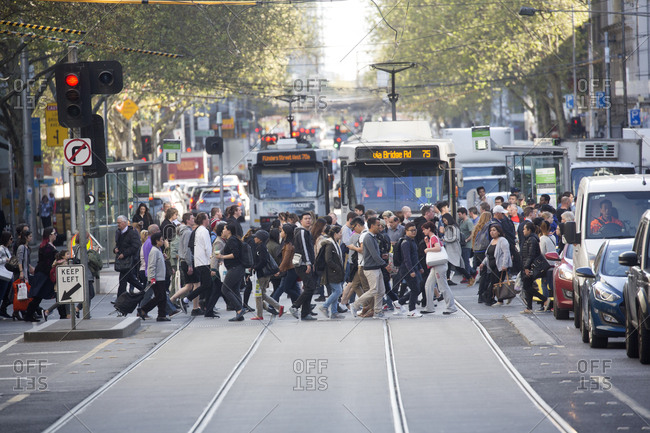 Melbourne, Australia - September 26, 2017: Busy crowd crossing Collins  street in Melbourne, Australia stock photo - OFFSET