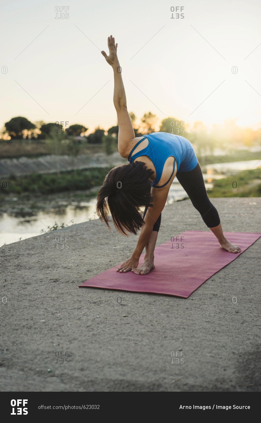 Mature Woman Outdoors Bending Over In Yoga Position Stock Photo Offset