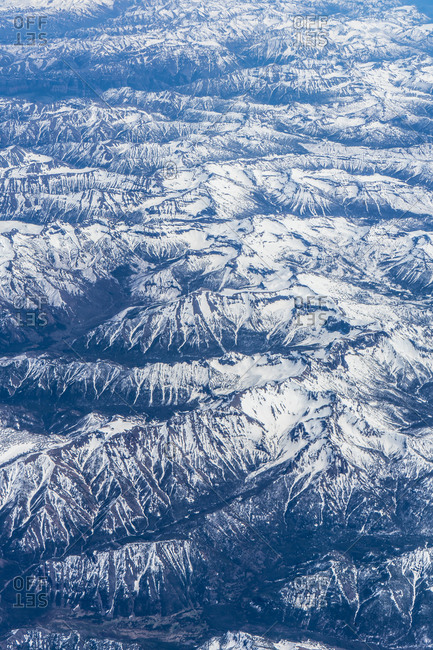 Aerial shot of mountains range with snowy caps