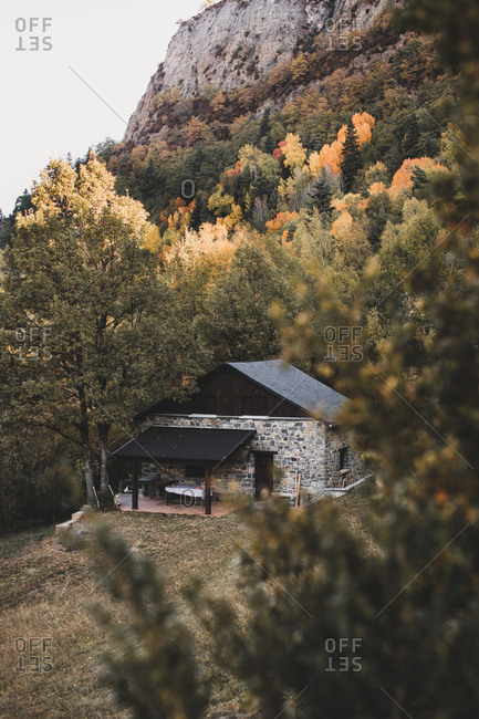 Small house built in forest in autumn mountains