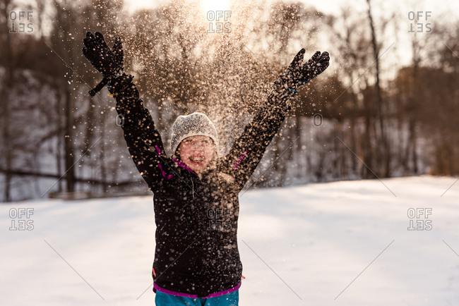 Girl throwing snow in the air