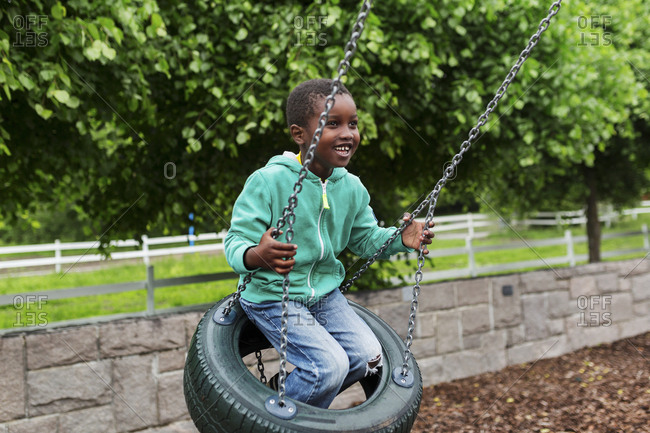 Boy on tire swing