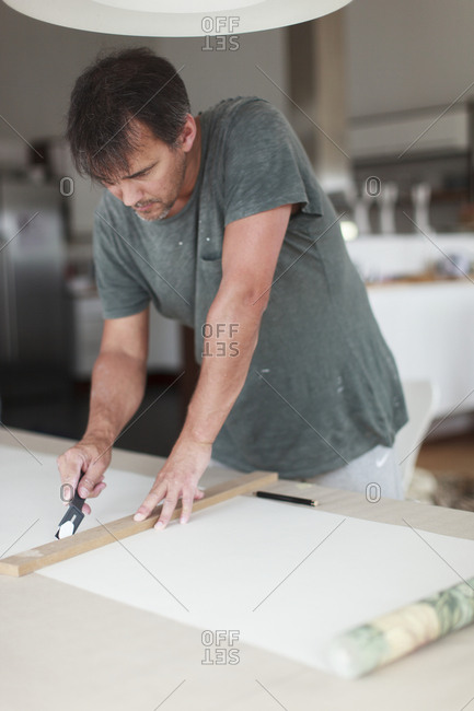 Man preparing wallpaper - Offset Collection