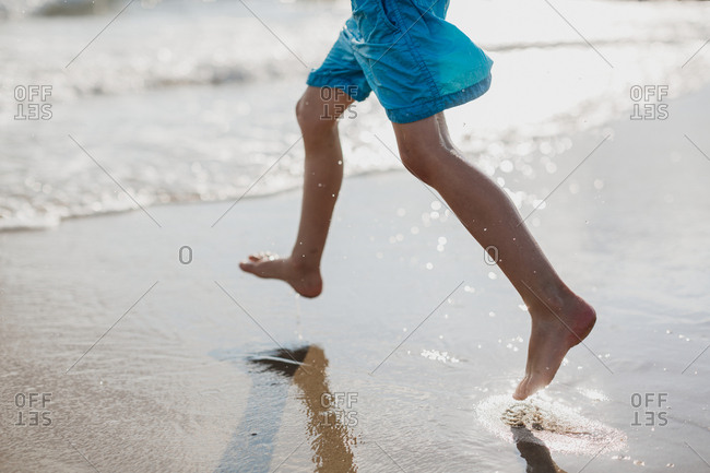 Boy running on beach - Offset