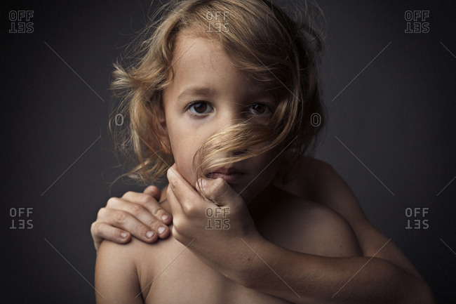 Portrait of child with arm wrapped around him