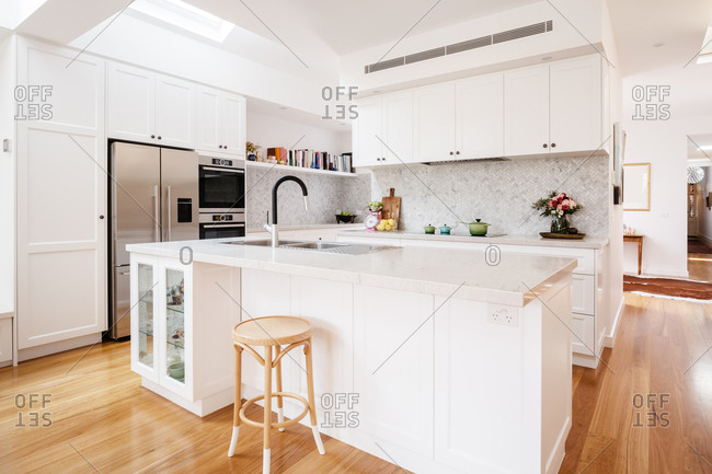 Stunning designer white kitchen renovation with large island counter top