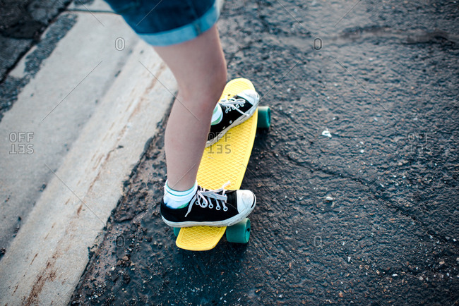 Legs of a girl riding a skateboard