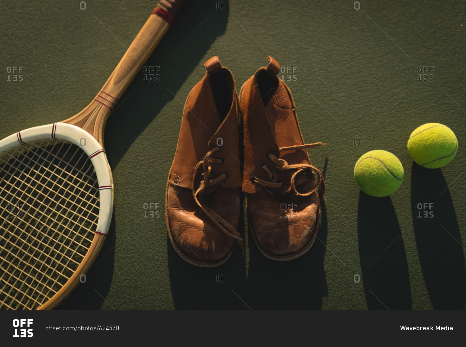 Close-up of tennis ball, sports shoes and racket in ground
