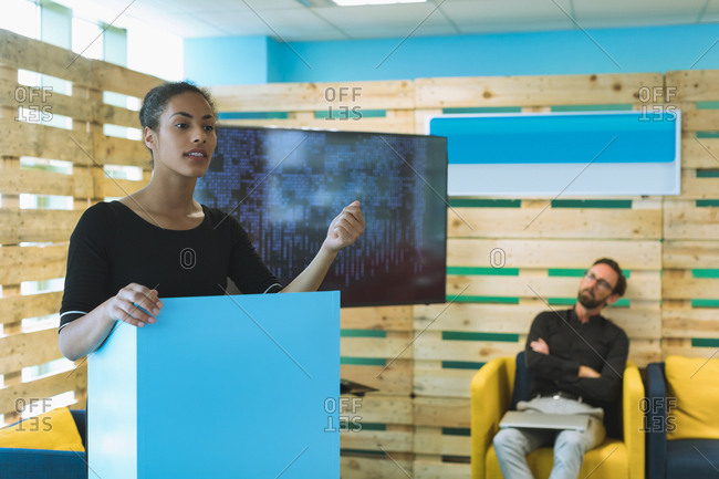 Confident female executive giving presentation in office