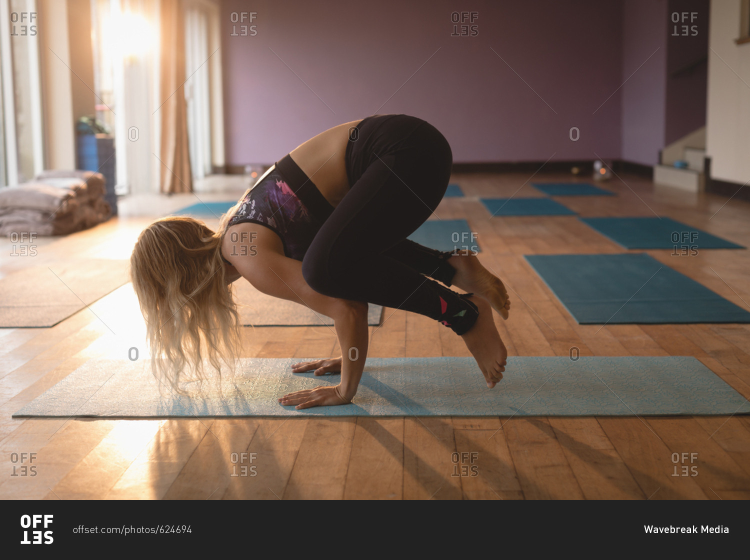 Fitness woman doing yoga handstand in yoga class