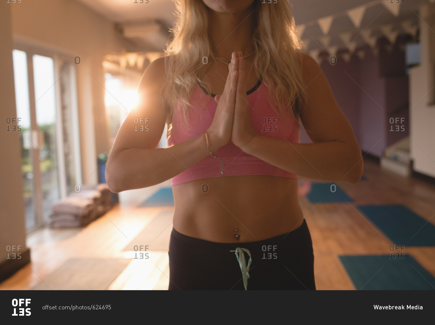 Fit woman doing yoga exercise in yoga class