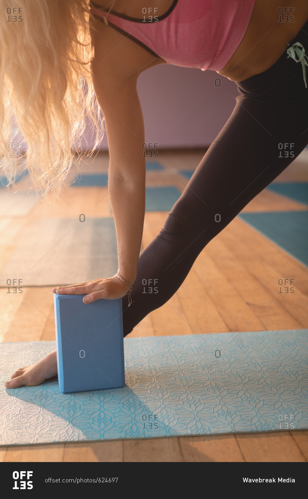 Fit woman doing stretching exercise in yoga class