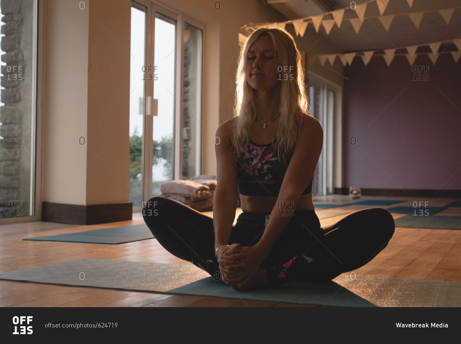 Woman doing meditation exercise in yoga class