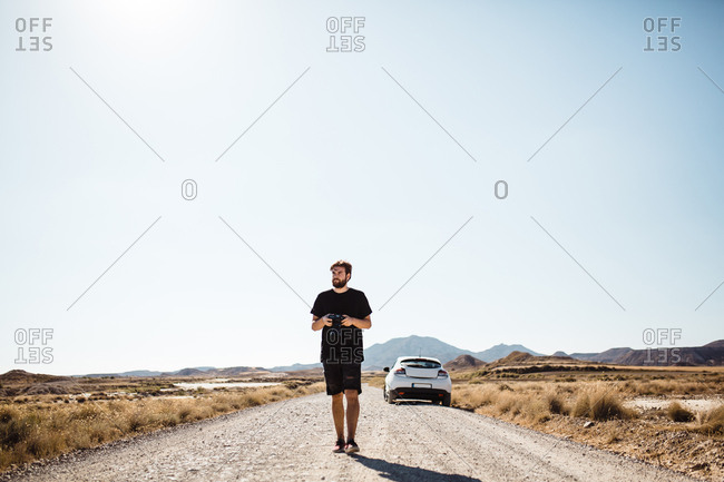 man walking away on the road