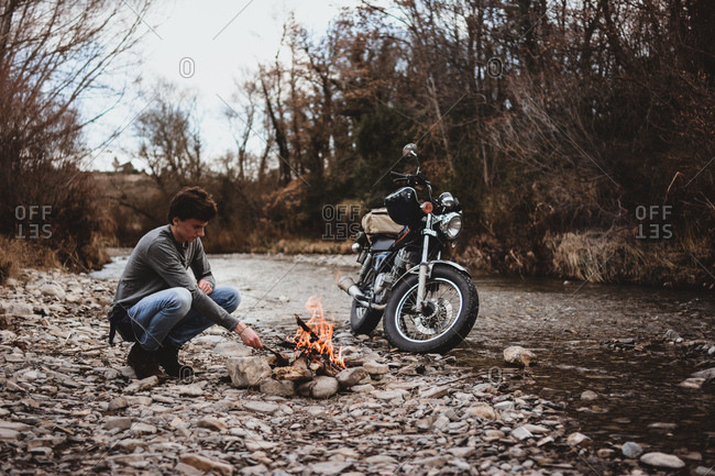 Traveler keeping camp fire